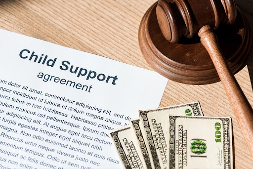 Money, a gavel, and child support papers, answering, “How Is Child Support Calculated?”